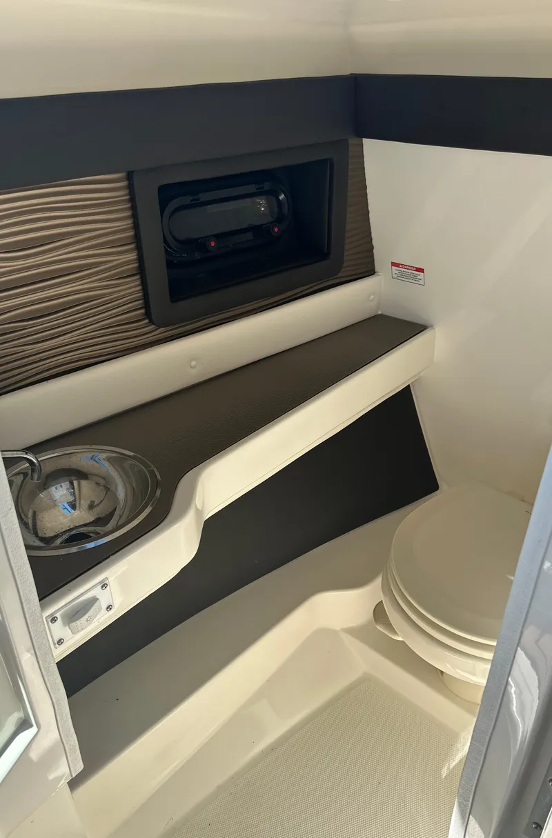 Slide: The Image of 2019 Sea Ray SLX 280 boat interior with storage and toilet. - 46