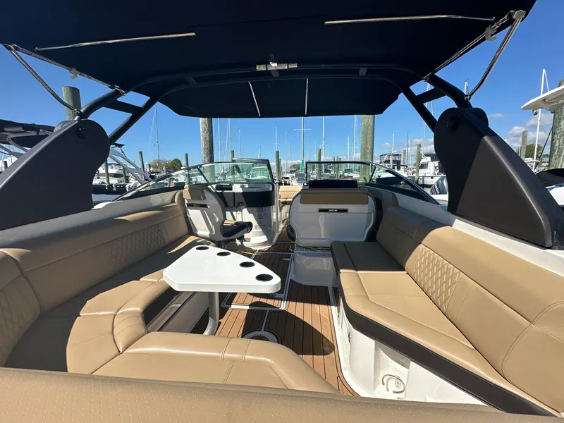 Slide: The Image of 2019 Sea Ray SLX 280 boat interior with tan seating and a central table. - 7