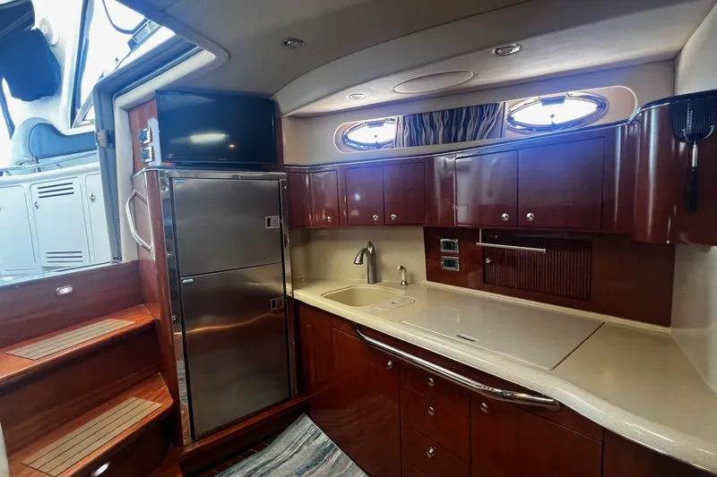 Slide: The Image of Luxurious 2003 Sea Ray 410 Express Cruiser kitchen with sleek cabinetry and modern appliances. - 14