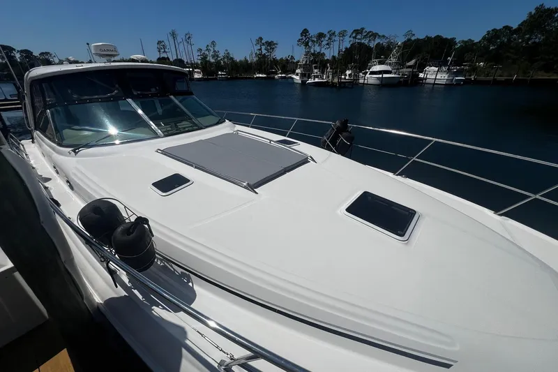 Slide: The Image of 2003 Sea Ray 410 Express Cruiser docked at marina, sunny day, calm waters. - 15