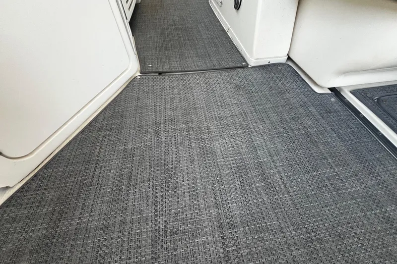 Slide: The Image of Gray woven flooring on 2003 Sea Ray 410 Express Cruiser interior. - 16