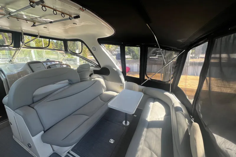 Slide: The Image of Luxurious interior of 2003 Sea Ray 410 Express Cruiser with plush seating and table. - 17
