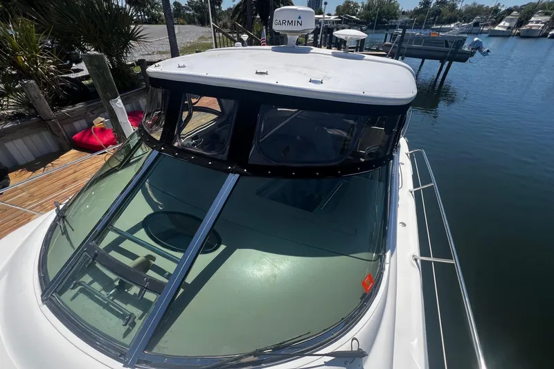 Slide: The Image of 2003 Sea Ray 410 Express Cruiser docked, featuring sleek design and Garmin navigation system. - 19