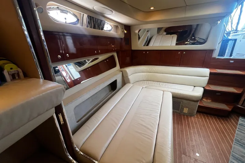 Slide: The Image of Luxurious interior of a 2003 Sea Ray 410 Express Cruiser with leather seating and wood accents. - 24