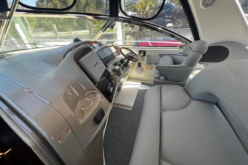 Slide: The Image of 2003 Sea Ray 410 Express Cruiser cockpit with modern navigation equipment and comfortable seating. - 26