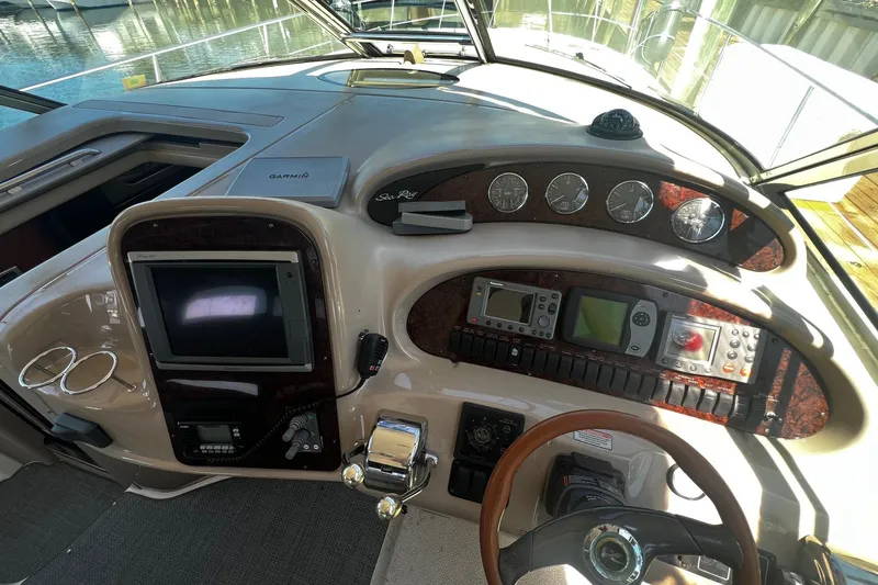 Slide: The Image of Cockpit of 2003 Sea Ray 410 Express Cruiser with navigation instruments and steering wheel. - 28
