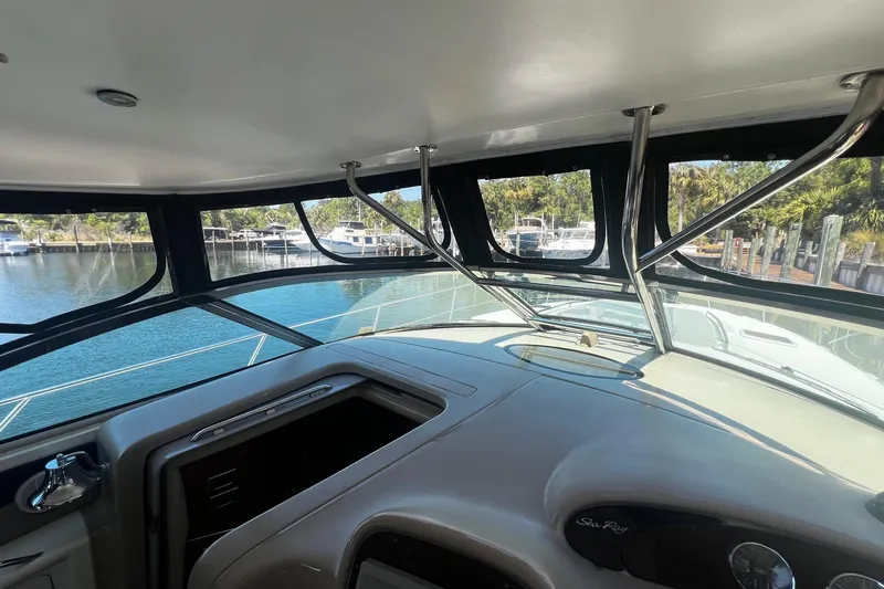 Slide: The Image of 2003 Sea Ray 410 Express Cruiser helm with marina view through large windows. - 29