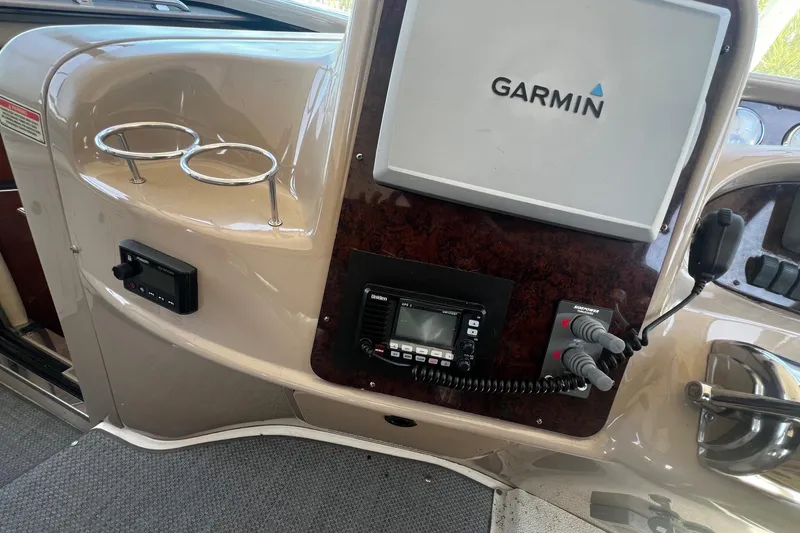 Slide: The Image of 2003 Sea Ray 410 Express Cruiser helm with Garmin navigation system and communication equipment. - 30