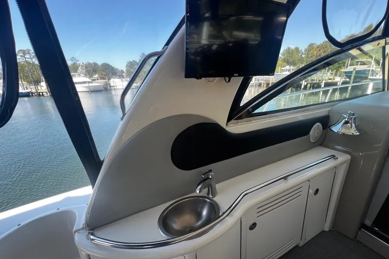 Slide: The Image of Interior view of 2003 Sea Ray 410 Express Cruiser with sink and mounted TV. - 32