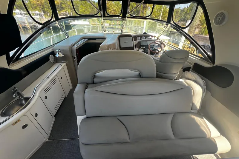 Slide: The Image of Interior of 2003 Sea Ray 410 Express Cruiser with helm, seating, and kitchenette. - 34