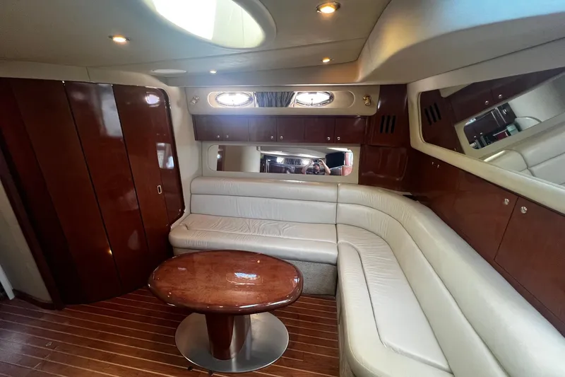 Slide: The Image of Luxurious interior of 2003 Sea Ray 410 Express Cruiser with leather seating and wooden finishes. - 35