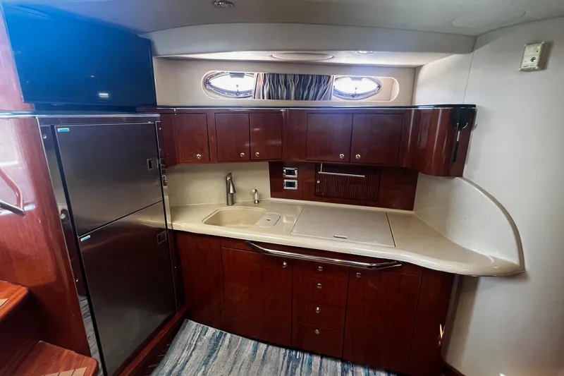Slide: The Image of Luxurious kitchen area in a 2003 Sea Ray 410 Express Cruiser yacht. - 37