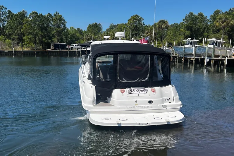 Slide: The Image of 2003 Sea Ray 410 Express Cruiser docked in a serene marina setting. - 4