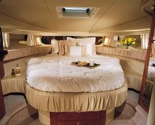 Slide: The Image of 2003 Sea Ray 410 Express Cruiser with blue underwater lights at night. - 47