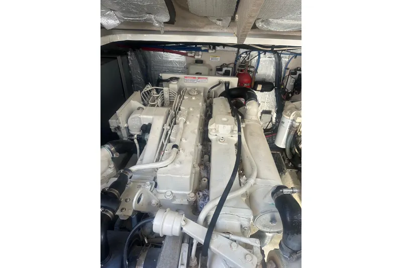 Slide: The Image of Engine compartment of a 2003 Sea Ray 410 Express Cruiser, showcasing mechanical components. - 52
