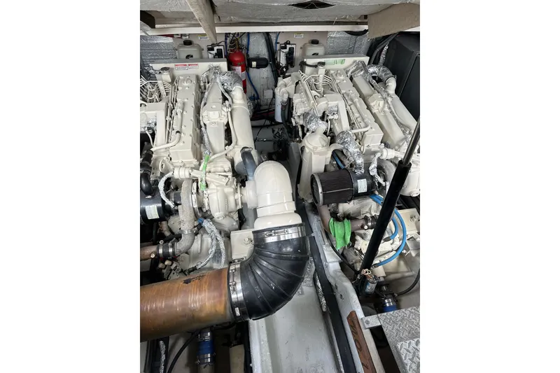 Slide: The Image of Engine room of a 2003 Sea Ray 410 Express Cruiser, showcasing dual engines. - 53