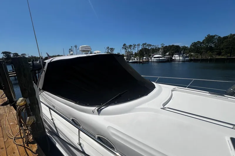 Slide: The Image of 2003 Sea Ray 410 Express Cruiser docked at a marina under clear blue skies. - 8