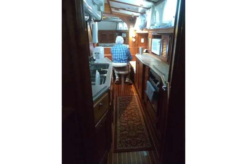 Slide: The Image of Interior of 1998 Gozzard 44 Center Cockpit yacht with person seated at table. - 3