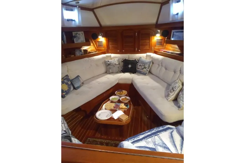 Slide: The Image of Luxurious interior of 1998 Gozzard 44 Center Cockpit yacht with plush seating and wooden accents. - 5