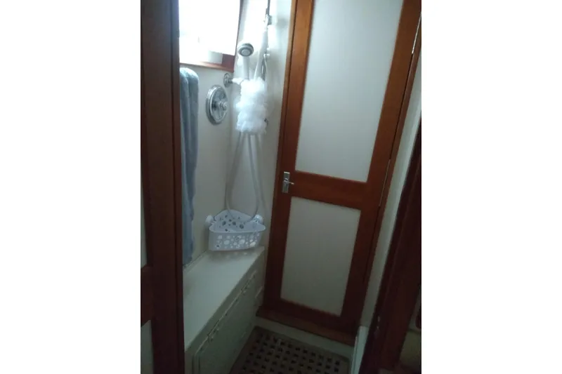 Slide: The Image of Shower area in 1998 Gozzard 44 Center Cockpit yacht with wooden door and towel rack. - 8