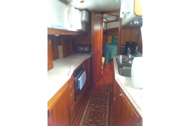 Slide: The Image of Interior of 1998 Gozzard 44 Center Cockpit yacht with wood cabinetry and cozy layout. - 9