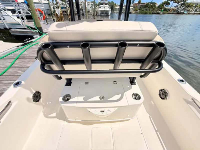 Slide: The Image of The image shows the cockpit of a Boston Whaler 220 Dauntless with rod holders and a water view. - 22