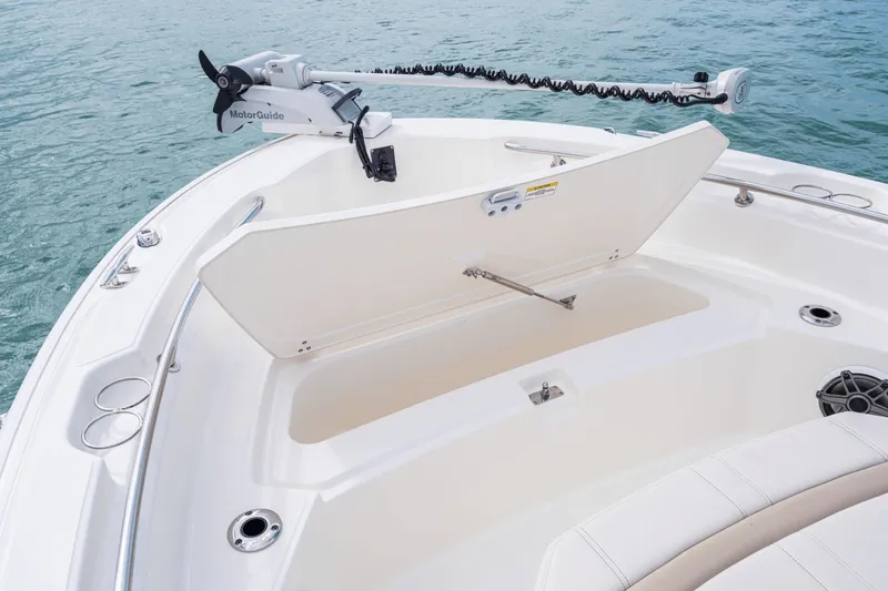 Slide: The Image of The image shows the bow of a Boston Whaler 220 Dauntless with an open storage compartment. - 38