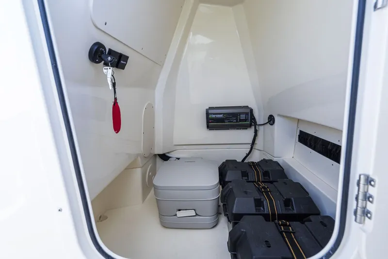 Slide: The Image of Interior of a Boston Whaler 220 Dauntless with a portable toilet and batteries. - 34