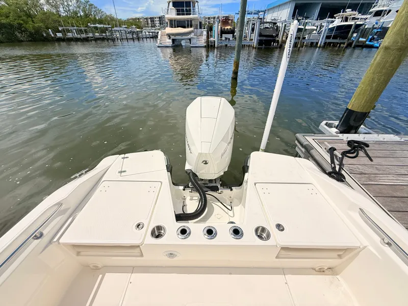 Slide: The Image of The image shows the stern of a Boston Whaler 220 Dauntless boat with an outboard motor. - 18