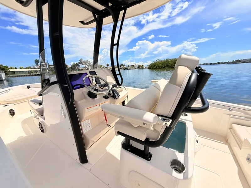 Slide: The Image of The image shows the cockpit of a 2027 Boston Whaler 220 Dauntless with a sleek helm station. - 25