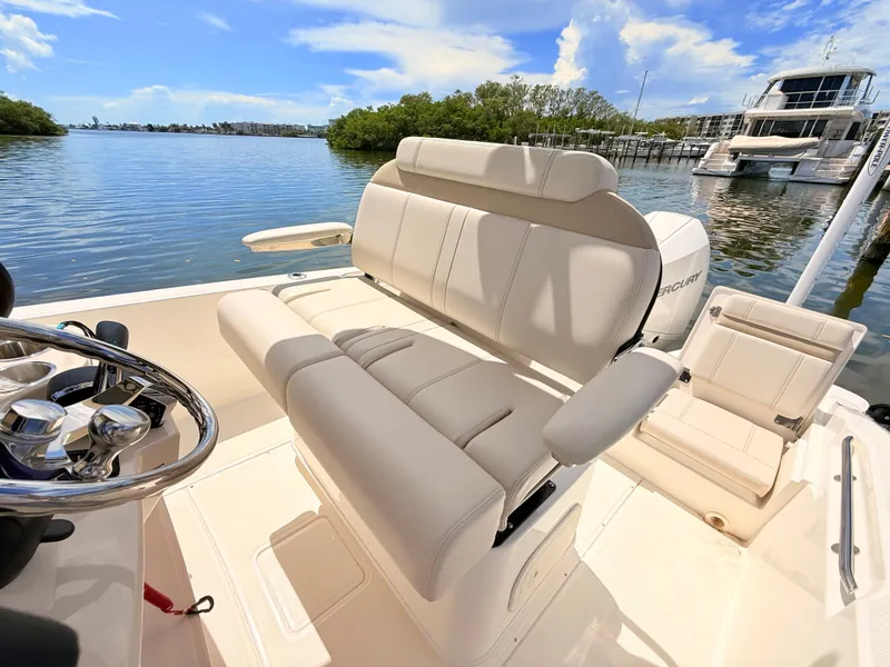 Slide: The Image of The image shows the cockpit of a 2027 Boston Whaler 220 Dauntless with beige seating. - 29