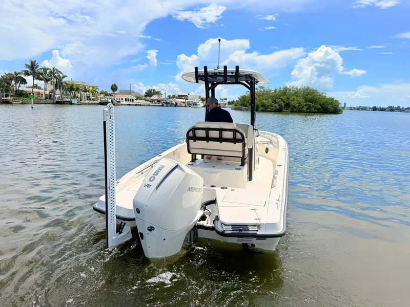 Slide: The Image of A 2027 Boston Whaler 220 Dauntless on calm water. An outboard motor is visible. - 12