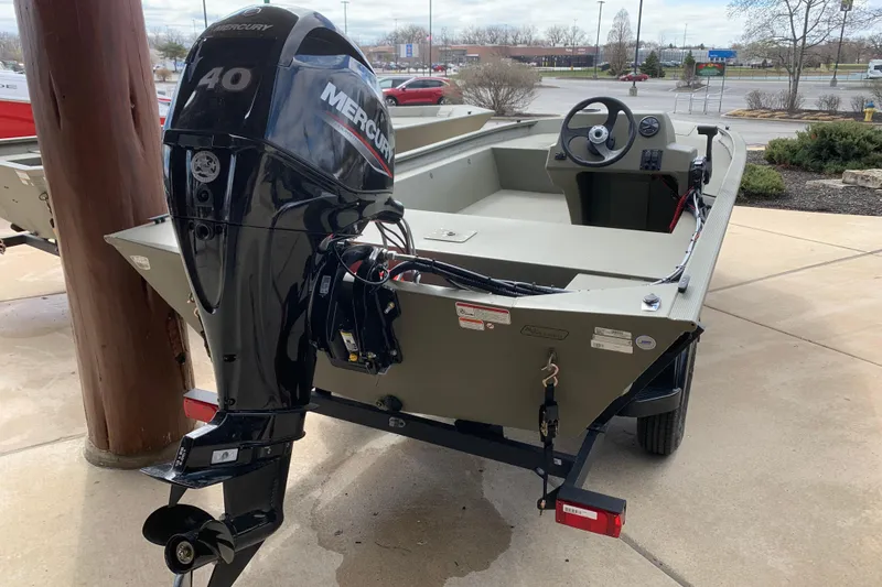 Slide: The Image of 2026 Tracker Grizzly 1754 SC boat with Mercury 40 engine, parked outdoors. - 5