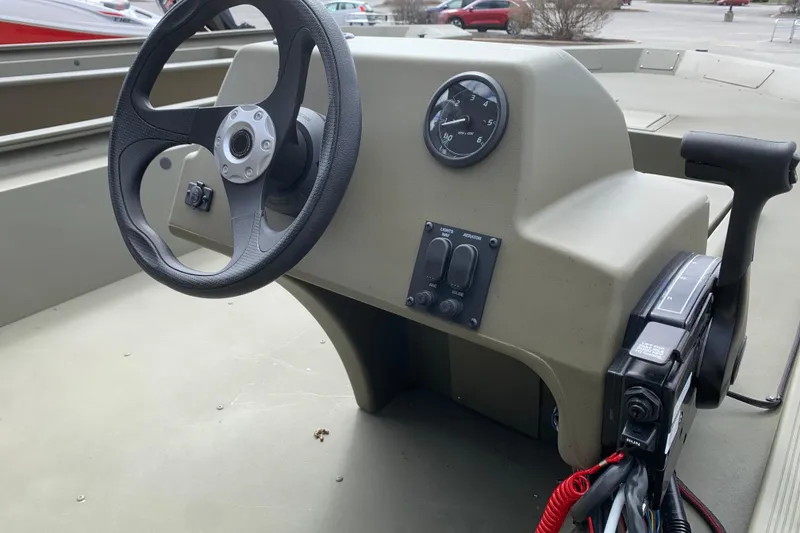 Slide: The Image of 2026 Tracker Grizzly 1754 SC All-Welded boat console with steering wheel and controls. - 6