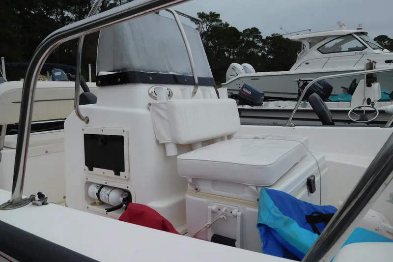 Slide: The Image of 2004 Boston Whaler 170 Montauk boat interior with seating and storage compartments. - 3