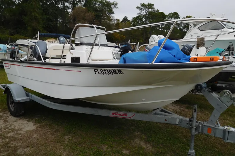Slide: The Image of 2004 Boston Whaler 170 Montauk boat on trailer, parked outdoors. - 4