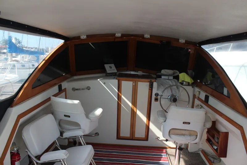 Slide: The Image of 1988 Cape Dory 28 Hardtop boat interior with helm, seating, and nautical decor. - 11