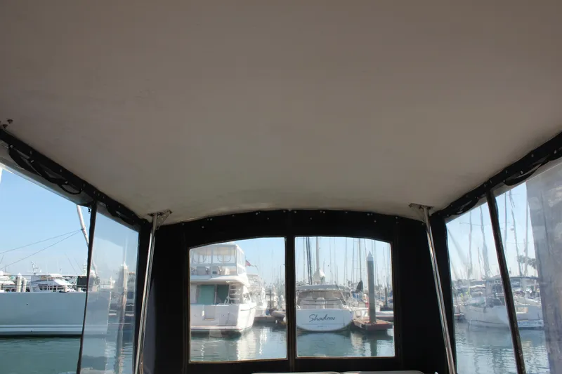Slide: The Image of Interior view from a 1988 Cape Dory 28 Hardtop boat, overlooking a marina. - 13
