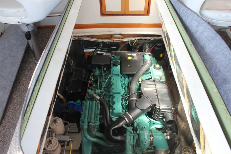 Slide: The Image of Engine compartment of a 1988 Cape Dory 28 Hardtop boat, showcasing detailed machinery. - 26