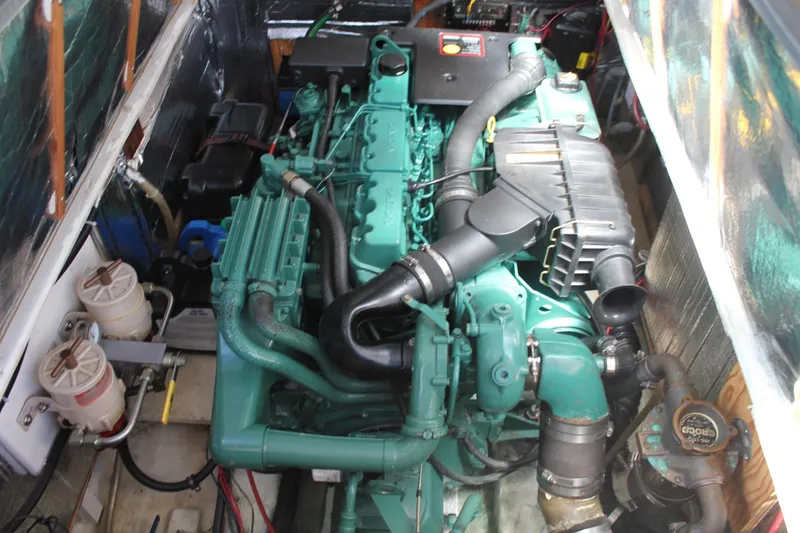 Slide: The Image of Engine compartment of a 1988 Cape Dory 28 Hardtop boat, showcasing detailed machinery. - 27