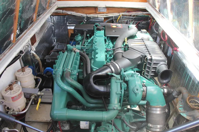 Slide: The Image of Engine compartment of a 1988 Cape Dory 28 Hardtop boat, featuring a green marine engine. - 28
