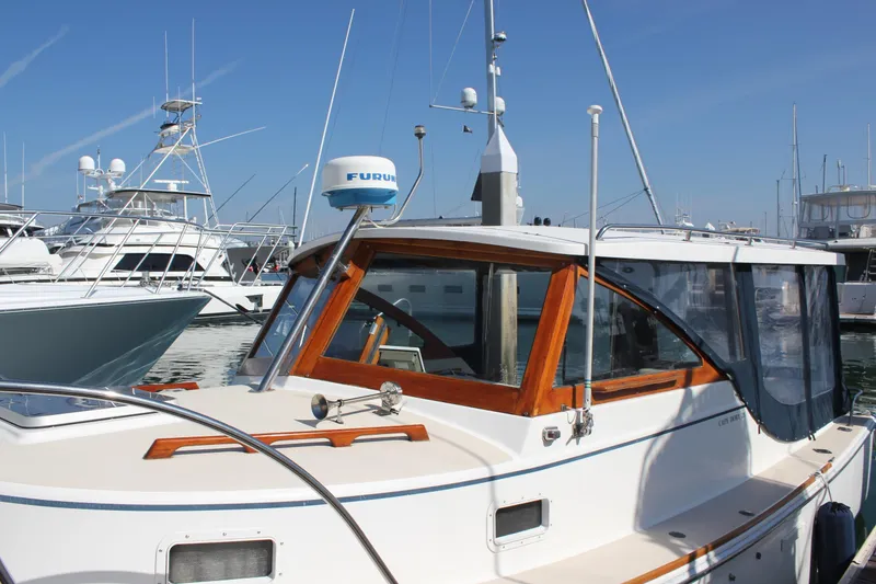 Slide: The Image of 1988 Cape Dory 28 Hardtop boat docked at marina under clear blue sky. - 3
