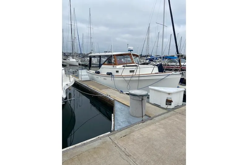 Slide: The Image of 1988 Cape Dory 28 Hardtop boat docked at marina, overcast sky. - 32