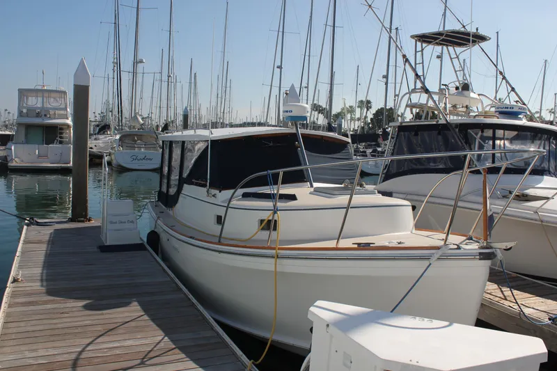 Slide: The Image of 1988 Cape Dory 28 Hardtop docked in a marina, surrounded by other boats. - 4