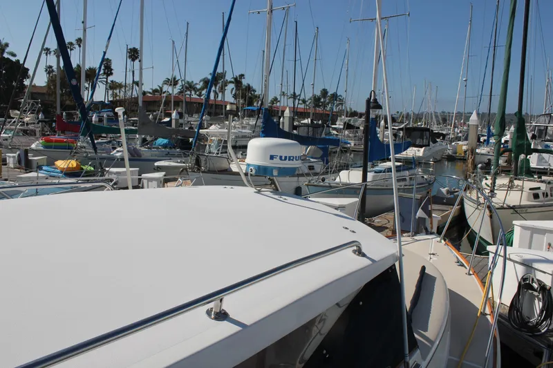 Slide: The Image of 1988 Cape Dory 28 Hardtop boat docked in a busy marina with sailboats. - 9