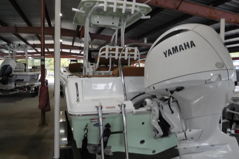 The Image of 2026 Sea Hunt Ultra 219 boat with Yamaha engine in covered storage. - 1
