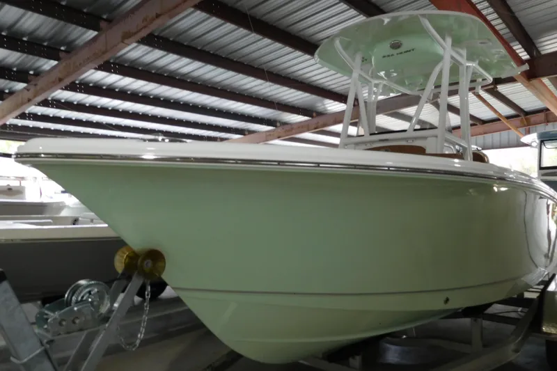 Slide: The Image of 2026 Sea Hunt Ultra 219 boat in storage, showcasing sleek design and modern features. - 3