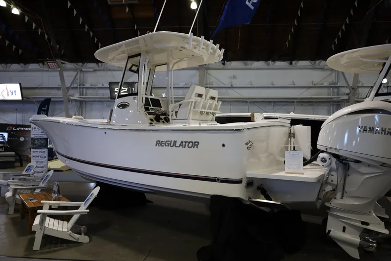Slide: The Image of 2025 Regulator 25 boat displayed indoors with Yamaha engine. - 22