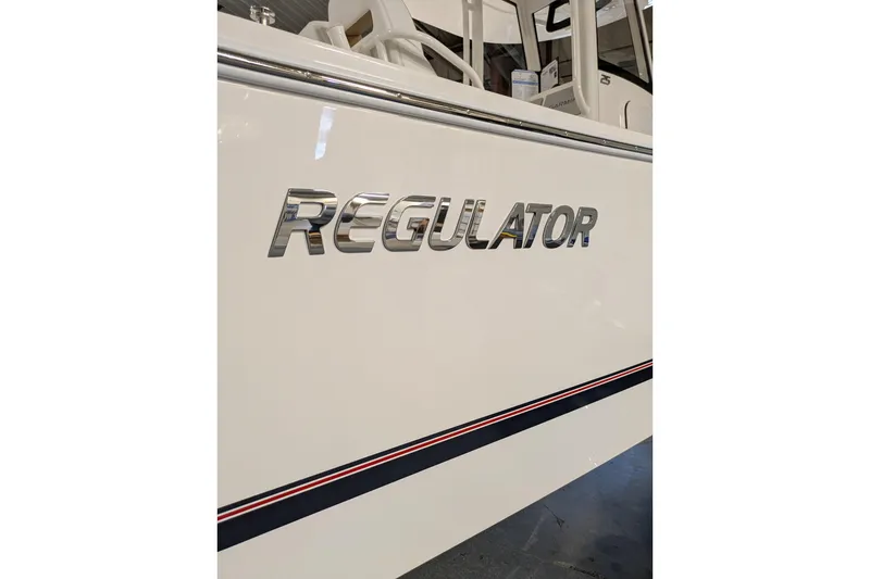 Slide: The Image of Regulator 25 boat logo on sleek white hull, 2025 model. - 24