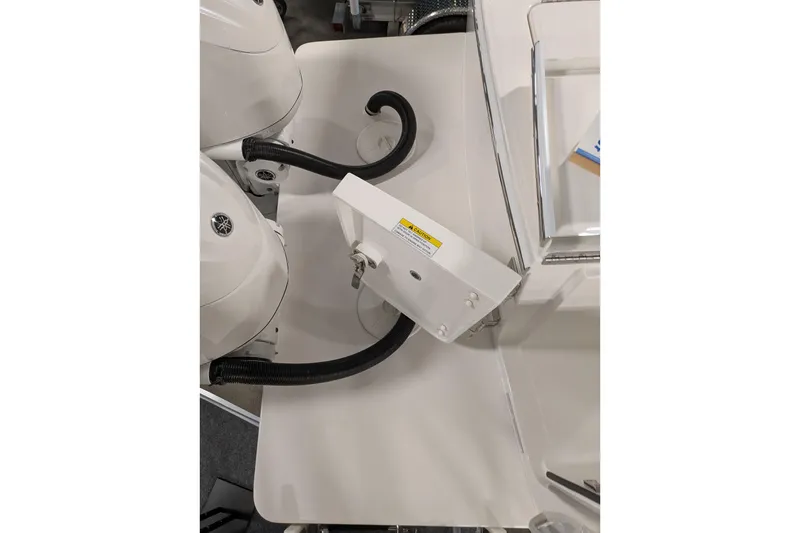 Slide: The Image of 2025 Regulator 25 boat engine compartment with Yamaha components and wiring. - 26